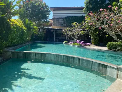 a swimming pool in the middle of a garden at Paradise Haven in Nusa Dua in Nusa Dua