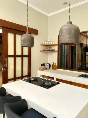 two metal pendant lights hanging over a kitchen island at Paradise Haven in Nusa Dua in Nusa Dua