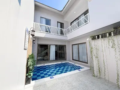 a villa with a swimming pool in a house at Bellagio Villas in Seminyak