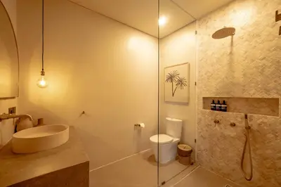 a bathroom with a shower and a toilet and a sink at Casanna Umalas in Canggu