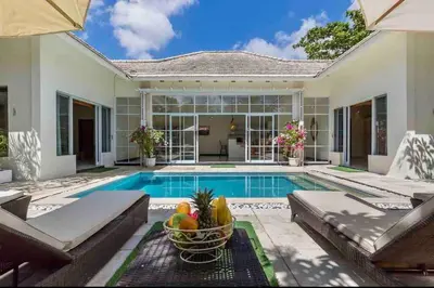 a home with a swimming pool and a house at Spacious 2bdr Seminyak walking eat&shop street in Seminyak