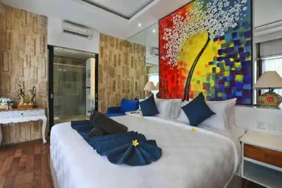 a bedroom with a large bed with a large painting on the wall at Amara Villa Umalas Bali in Canggu