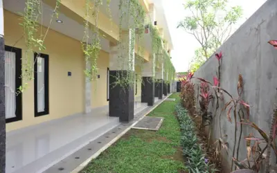 a hallway of a building with plants on the side at Bali Mega Hotel in Jimbaran