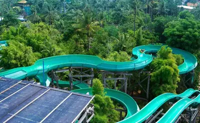 an amusement park with a water slide in the forest at Losari Sunset Hotel in Kuta