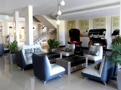 a lobby with couches and chairs and a piano at Losari Sunset Hotel in Kuta