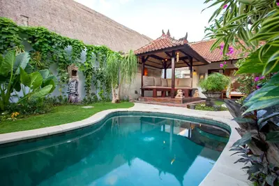 a swimming pool in front of a house at Villa Chantal-Intimate Villa in Seminyak in Seminyak