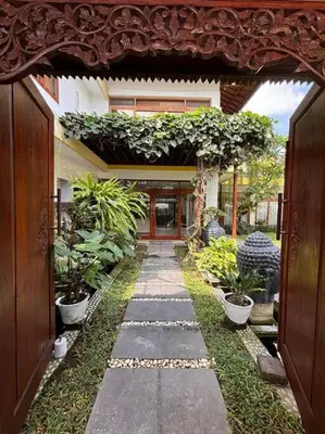 an entrance to a house with plants and a walkway at 4 Bedroom Tropical Luxury Villa in Seminyak