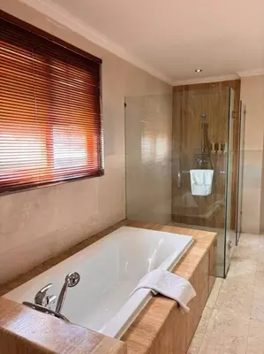 a large bathroom with a tub and a shower at 4 Bedroom Tropical Luxury Villa in Seminyak