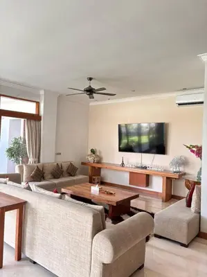 a living room with a couch and a table at 4 Bedroom Tropical Luxury Villa in Seminyak
