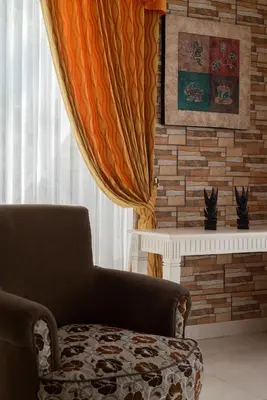 a living room with a chair and a fireplace at Villa with view rooftop in Nusa Dua Bukit in Nusa Dua