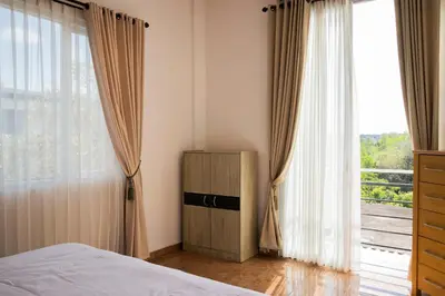 a bedroom with a bed and a large window at Villa with view rooftop in Nusa Dua Bukit in Nusa Dua