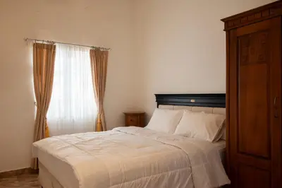 a bedroom with a bed and a window at Villa with view rooftop in Nusa Dua Bukit in Nusa Dua