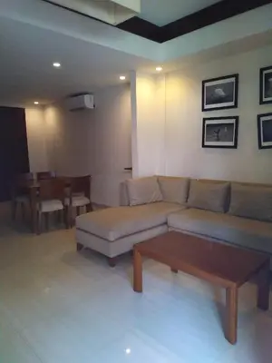a living room with a couch and a table at Seminyak Apartment by LBV in Seminyak