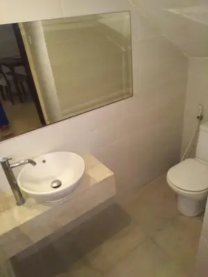 a bathroom with a sink and a toilet at Seminyak Apartment by LBV in Seminyak