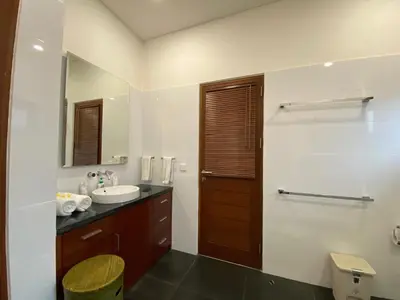 a bathroom with a sink and a mirror at ViLLA GREEN MANGGO III in Seminyak