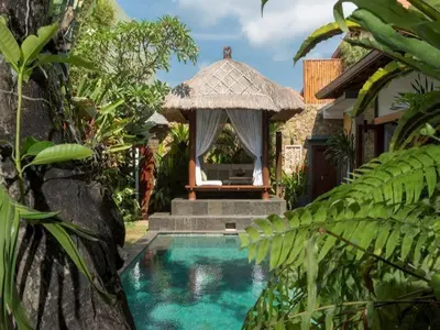 a resort with a swimming pool with a gazebo at ViLLA GREEN MANGGO III in Seminyak