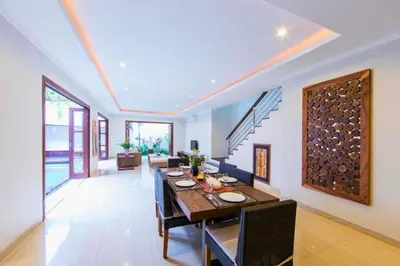 a dining room and living room with a table and chairs at Divija 2 BR Private Pool Villa in Seminyak