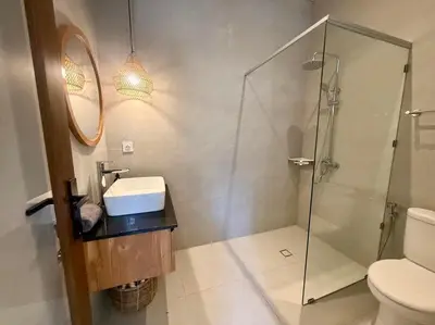 a bathroom with a shower and a sink and a toilet at Villa NANEE - Legian - 5 Bedroom - 5 Bathroom in Legian