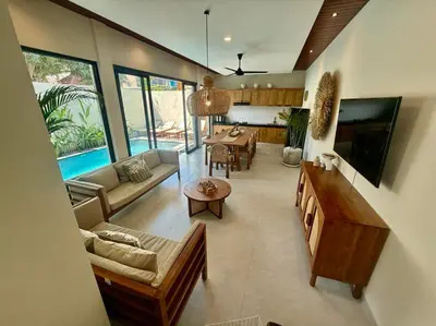 a living room with a couch and a table at Villa NANEE - Legian - 5 Bedroom - 5 Bathroom in Legian