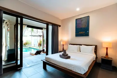 a bedroom with a bed with a teddy bear on it at Villa Damira in Seminyak