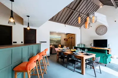 a dining room with a table and chairs at Villa Damira in Seminyak