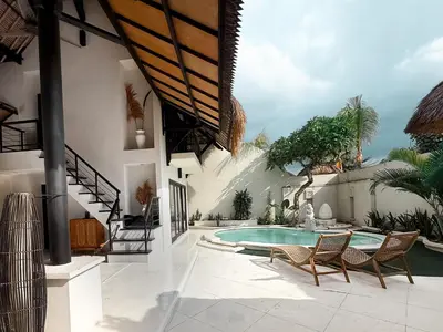 a patio with a pool and chairs and a house at Villa Malicott Athena - 3C in Seminyak