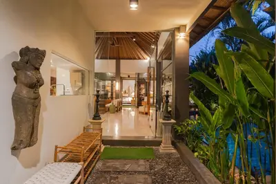 a lobby of a house with a statue on the wall at Akhira One Seminyak in Seminyak