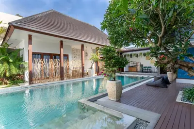 a swimming pool in front of a house at Rumah Impian Villa by Betterplace in Canggu