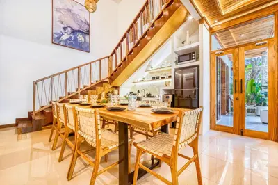 a dining room with a wooden table and chairs at Villa Chicago Brand new 7 BDR private pool in Seminyak