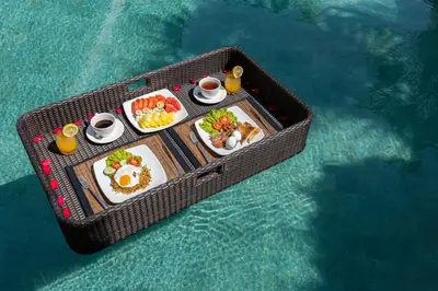 a tray of food on a table in the water at Spacious 4BR Villa with Pool in Central Seminyak in Seminyak