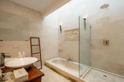 a bathroom with a tub and a sink and a shower at Spacious 4BR Villa with Pool in Central Seminyak in Seminyak
