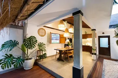 a living room with a table and some plants at Bubble Villa & Rice field view in Kerobokan