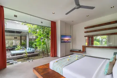 a bedroom with a large bed and a large window at Stunning 4 Bed, Butler Service, Security, Central in Seminyak