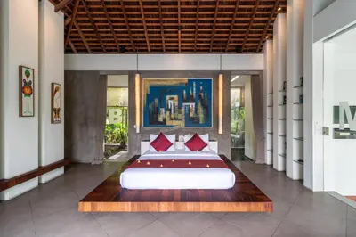 a bedroom with a large bed with red pillows at Stunning 4 Bed, Butler Service, Security, Central in Seminyak