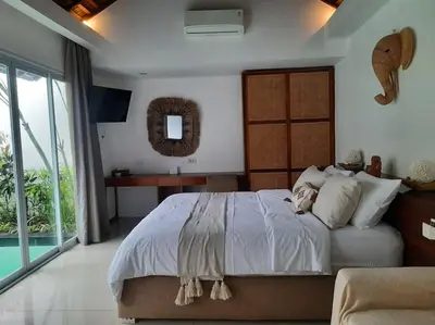 a bedroom with a large bed and a large window at Rove One-bedroom Pool Villa Seminyak in Seminyak