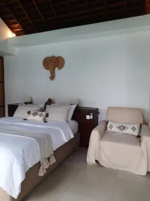a bedroom with two beds and a stuffed elephant on the wall at Rove One-bedroom Pool Villa Seminyak in Seminyak