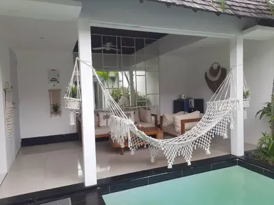 a living room with a hammock and a pool at Rove One-bedroom Pool Villa Seminyak in Seminyak