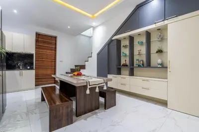 a kitchen with white cabinets and a wooden island at Villa Ashëla by JB Villas in Seminyak