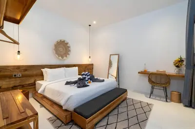 a bedroom with a large white bed in a room at Vajrayana - 10 Min From The Beach, Serene Villa with Pool View in Kerobokan