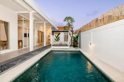 a swimming pool in the middle of a house at Vajrayana - 10 Min From The Beach, Serene Villa with Pool View in Kerobokan