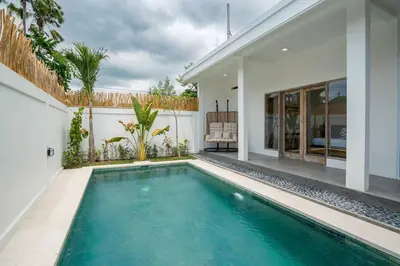 a swimming pool in the backyard of a house at Vajrayana - 10 Min From The Beach, Serene Villa with Pool View in Kerobokan