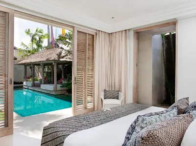 a bedroom with a bed and a swimming pool at Villa Adasa by Elite Havens in Seminyak