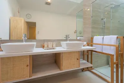 a bathroom with two sinks and a shower at Casa Elias Seminyak in Seminyak