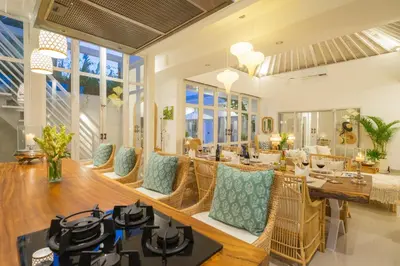 a living room with a table and chairs at Casa Elias Seminyak in Seminyak