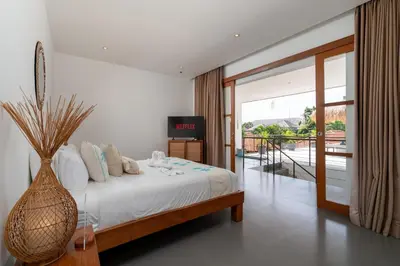 a bedroom with a bed with a vase at Beautiful modern villa in the heart of Seminyak in Seminyak