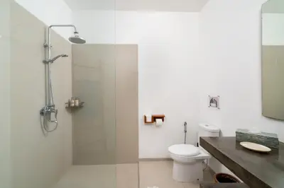 a bathroom with a shower with a toilet and a sink at Beautiful modern villa in the heart of Seminyak in Seminyak