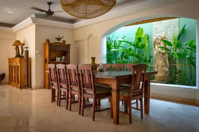 a dining room with a table and chairs and an aquarium at Onkita 4 BR Private Pool Villa ZN254 in Seminyak