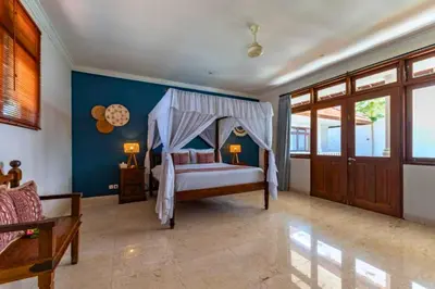 a bedroom with a bed with a canopy at Onkita 4 BR Private Pool Villa ZN254 in Seminyak