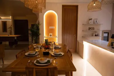 a kitchen with a wooden table with chairs and a counter at Villa Umi Paradise Bliss 3BD Villa in Prime Area in Umalas