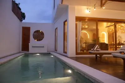 a swimming pool in a house with a living room at Villa Umi Paradise Bliss 3BD Villa in Prime Area in Umalas